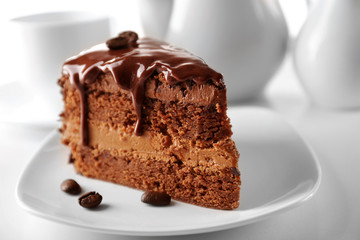 Delicious chocolate cake on plate on table on light background