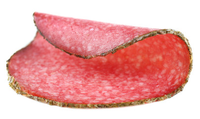 Slice of salami isolated on white background