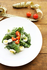 Salad with quail egg and basil in plate