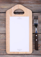 Cutting board with menu sheet of paper