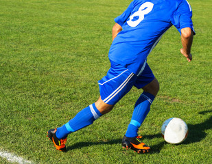 Soccer player with a ball © majorosl66