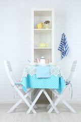 Fototapeta na wymiar Wooden chairs and table in cozy kitchen