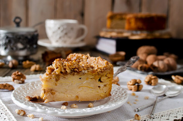 Piece of apple pie with walnut and sugar glaze