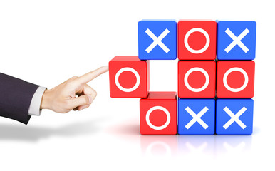 Hand pushing a circle to win the tic tac toe game