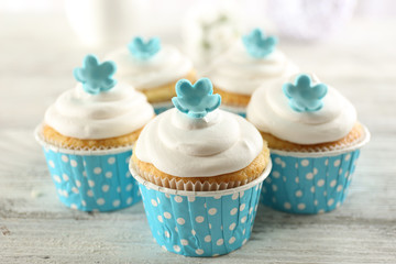 Delicious cupcakes on table on light background