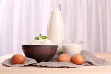 Tasty dairy products on table on fabric background