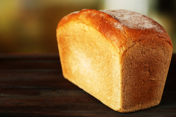 Fresh bread on table on bright background