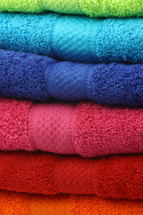 background of stacked colorful fluffy cotton  towels