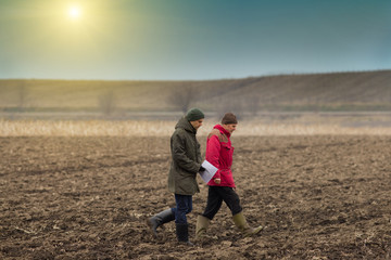 Farmers on plowed field