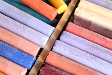 Colorful chalk pastels in box close up