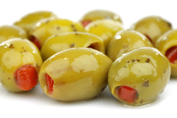 stuffed green olives on a white background