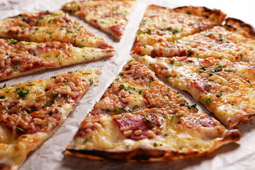 Tasty pizza on paper close up