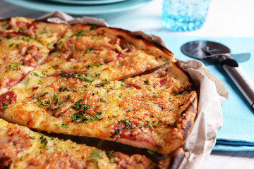 Tasty pizza with tableware on wooden table close up