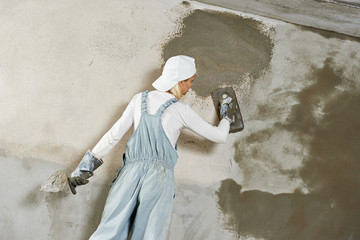 Plasterer at indoor wall work