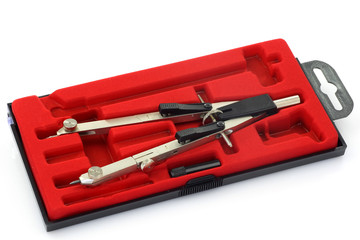 compasses in a red case on a white background