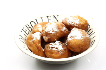 freshly baked traditional dutch oliebollen with powdered sugar
