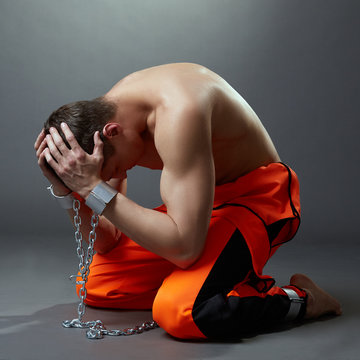 Concept of imprisonment. Prisoner grabbed his head