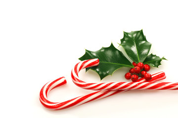 Christmas candy canes with a branch of holly