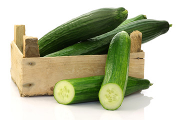 cucumbers in a wooden box on a white background