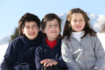 smiling three brothers in the mountains on snow