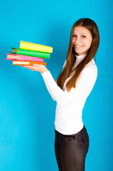 girl with colored books on a blue background