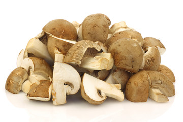 bunch of cut champignon mushrooms on a white background