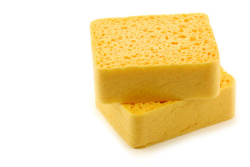 yellow household sponges on a white background