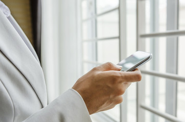 Hand of woman dialing smart phone