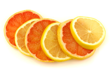 Naklejka na ściany i meble yellow and red grapefruit slices on a white background