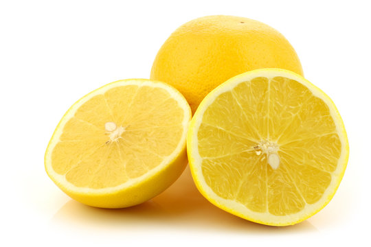 yellow grapefruit and a cut one on a white background