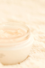 Obraz na płótnie Canvas Cosmetic cream in jar close up shallow DOF