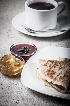 Russian pancakes - blini with cup of tea and jam. Toned