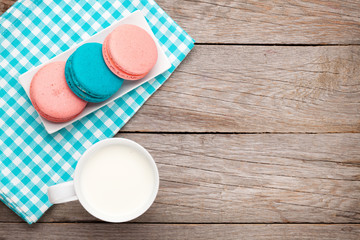 Obraz na płótnie Canvas Colorful macaron cookies and cup of milk