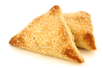 bunch of freshly baked apricot turnovers on a white background
