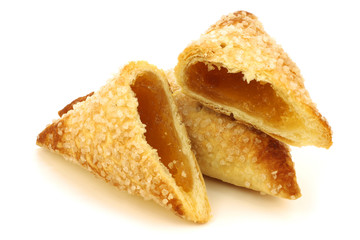 bunch of freshly baked apricot turnovers on a white background