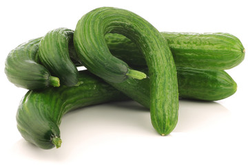 bunch of curly turkish cucumbers on a white background