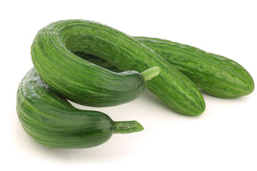 bunch of curly turkish cucumbers on a white background