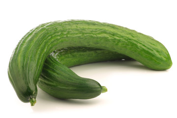bunch of curly turkish cucumbers on a white background