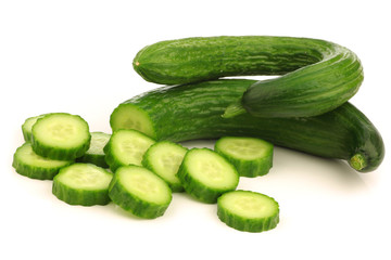 bunch of curly turkish cucumbers on a white background