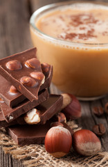 Stack of chocolate with nuts beans of coffe and star anise