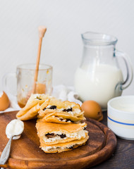 thin pancakes with cottage cheese, prunes, honey and sour cream