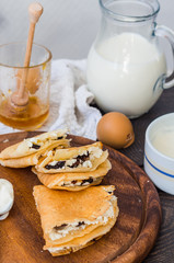 thin pancakes with cottage cheese, prunes, honey and sour cream