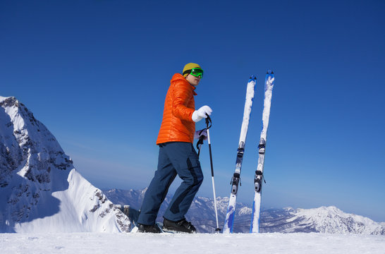 Young man standing alone with ski in snow
