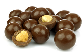 chocolate balls filled with hazelnuts on a white background