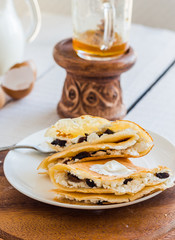 thin pancakes stuffed with cheese, prunes and sour cream, milk