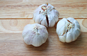 Garlic bulbs on wooden plank