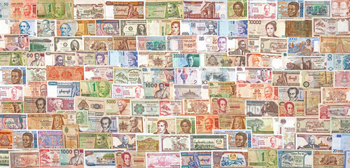Banknotes from all over the world overlapping each other.