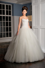 Full-length beautiful Bride in wedding dress. Studio.