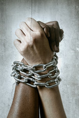 white race hand chain locked together with black ethnicity hand