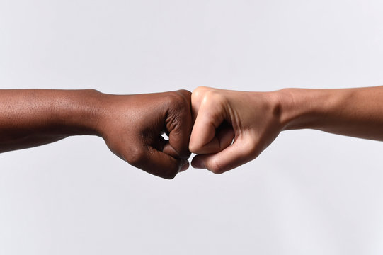 black African American and white Caucasian hands racism concept